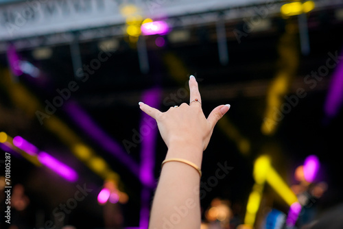 Close Up Of Person Making Rock And Roll Hand Gesture At Outdoor Summer Music Festival © Monkey Business
