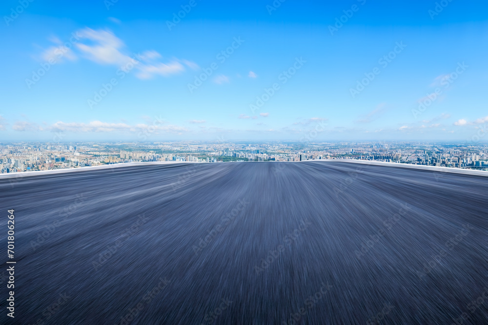 Fototapeta premium Motion blurred asphalt road and city skyline