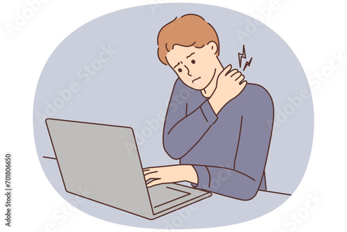 Tired man suffer from backache working on computer