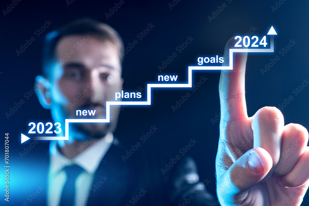 Businessman sets goals for 2024. Man draws graph on virtual screen. Staircase with strategy for year. Business man is planning. Blurred manager prepares plan. Corporate planning. Business goals Businessman sets goals for 2024. Man draws graph on virtual screen. Staircase with strategy for year. Business man is planning. Blurred manager prepares plan. Corporate planning. Business goals