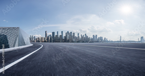 Motion blurred asphalt road and city skyline