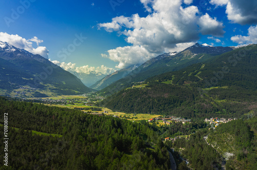 beautiful panorama of an Italian valley during springtime with the sun illuminating the valley and the blue sky