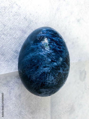 Easter egg painted in cosmic blue for the sacred holiday

