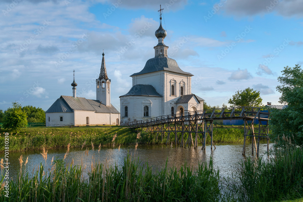View of the Epiphany and Nativity Churches in Kozhevennaya Sloboda and the Kamenka River on a sunny summer day, Suzdal, Vladimir region, Russia