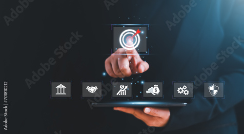 Businessman pointing hand at business target symbol icon with business strategy and action plan, targeting business concept, business development concept.