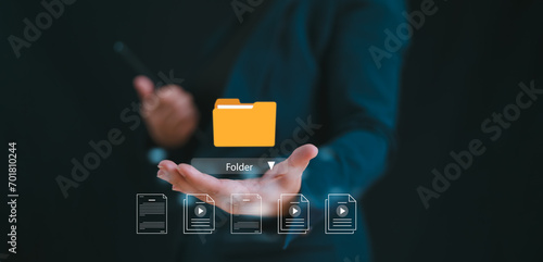 Document management system concept, business man holding folder and document icon software, searching and managing files online document database, for efficient archiving and company data.