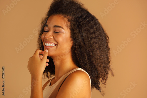 Close up portrait in profile of joyful african american model with closed eyes expressing happiness