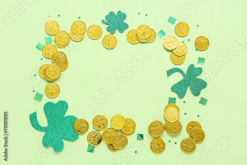 Frame made of golden coins, paper clovers and sequins on light green background. St. Patrick's Day celebration