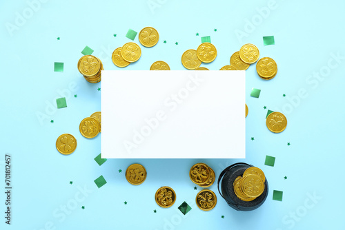 Blank card with golden coins, pot and sequins on blue background. St. Patrick's Day celebration