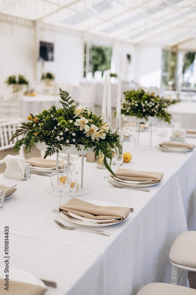 Decorated wedding tables with flowers and leaves