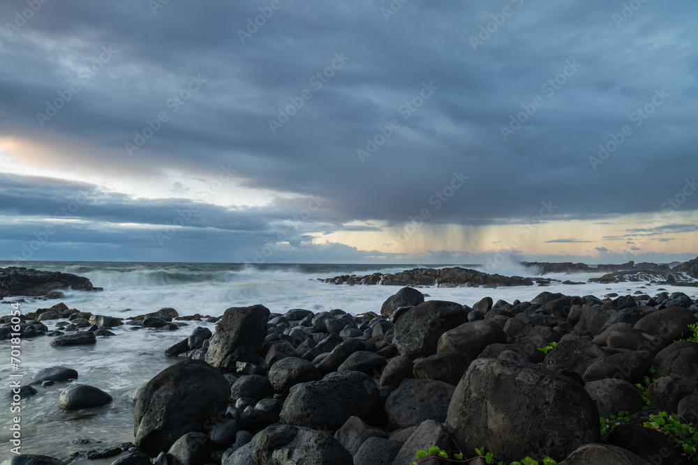 Long exposure view of waves crashing on the rocky shore of Benares beach during a rainy morning in Mauritius island Long exposure view of waves crashing on the rocky shore of Benares beach during a rainy morning in Mauritius island
