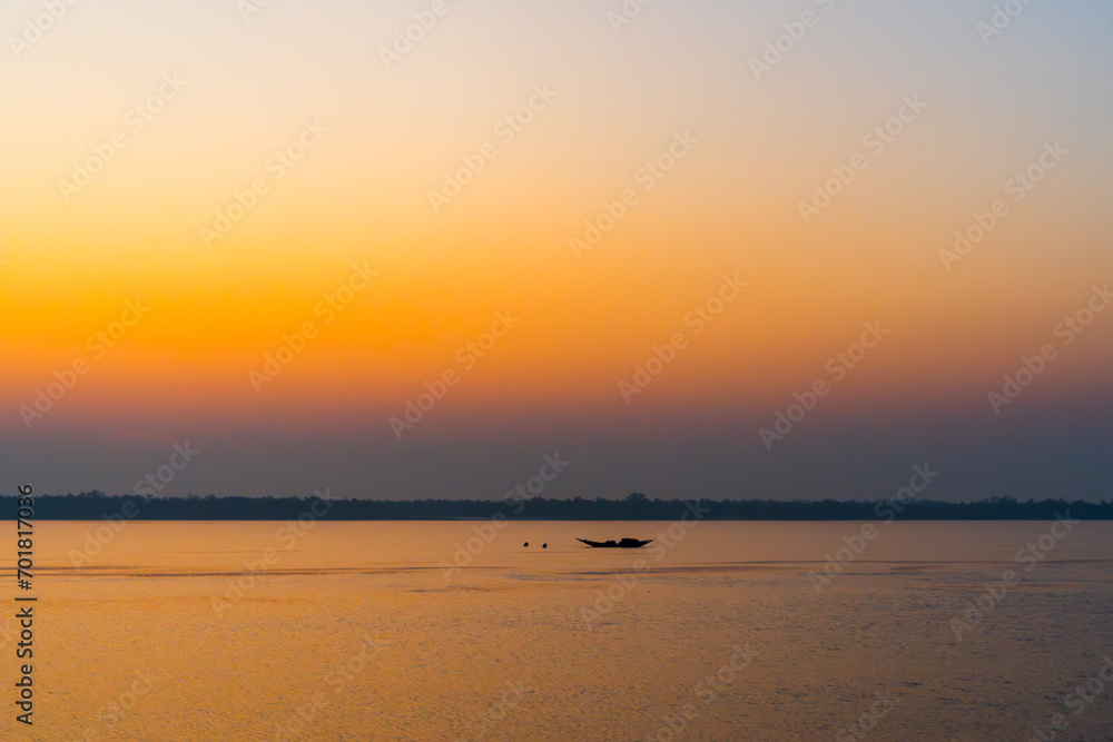 Beautiful Boat in river at dawn. Foggy landscape with boat during sunset on traditional boat in Sundarbans. 