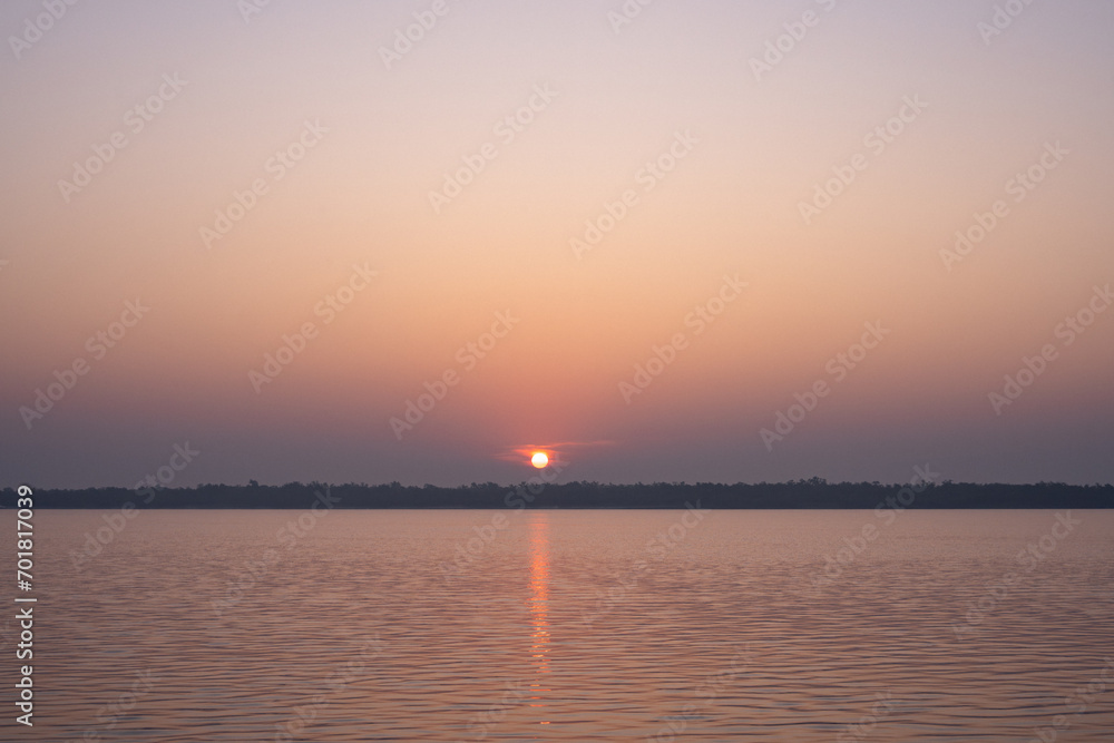 Naklejka premium Beautiful sunset sky with island. Sunset at the beach.