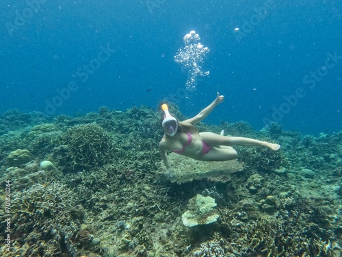 Young girl snorkeling at a coral reef in the Philippines. High quality photo
