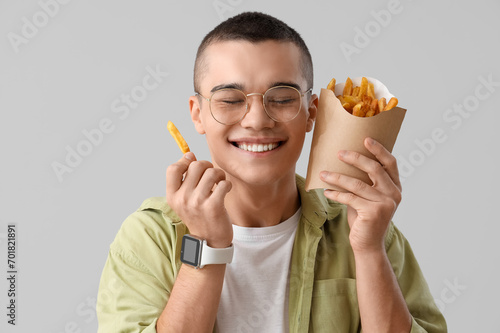 Young man with french fries...