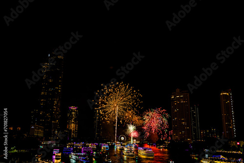 Firework show to celebrate of the new year 2024 along Chao Praya River with the night scene on Asiatique landmark side in Bangkok city, Thailand.