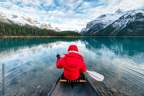 Male tourist canoeing in Spirit Island on Maligne Lake at Jasper national park, Canada