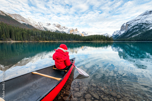 Male tourist canoeing in Spirit Island on Maligne Lake at Jasper national park, Canada