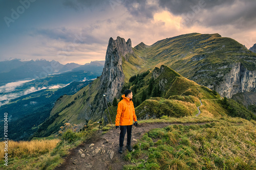 Landscape of rocky mountains of Saxer Lucke with male traveler hiking on Swiss Alps in autumn at Switzerland