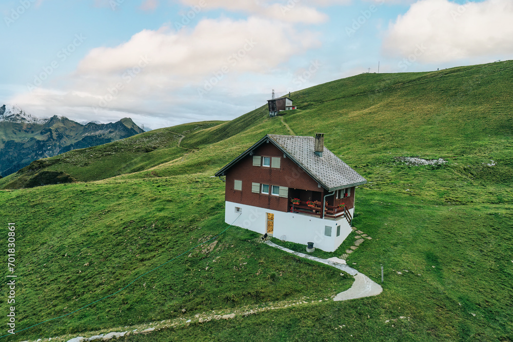 Wooden chalet on summit among the Schwyzer Alps in summer