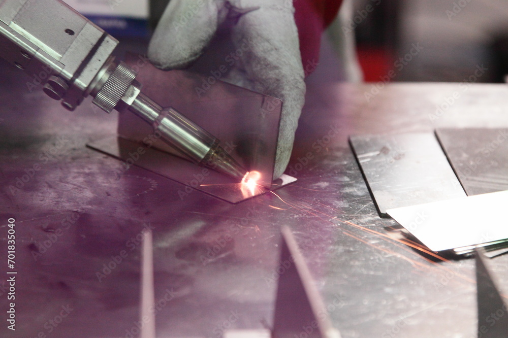 Laser beam welding of metal on welding table. LBW assembly details angle