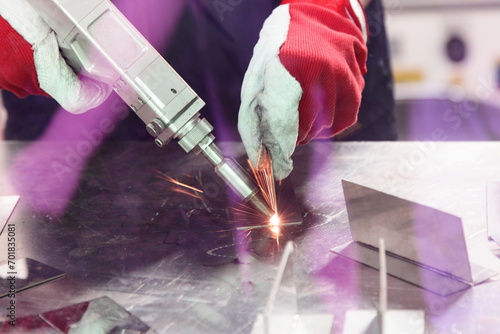 Laser beam welding of metal on welding table. LBW attention eyes