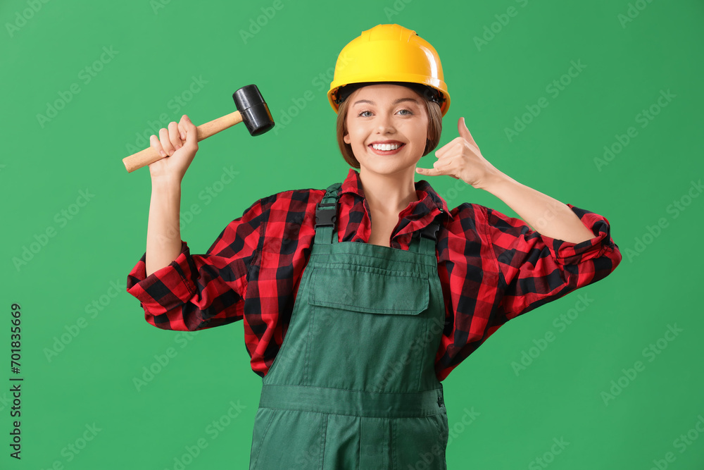 Female worker with hammer showing Female worker with hammer showing
