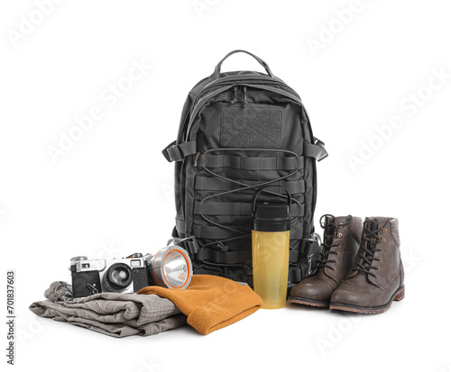 Set of camping equipment with backpack, photo camera and thermal bottle on white background