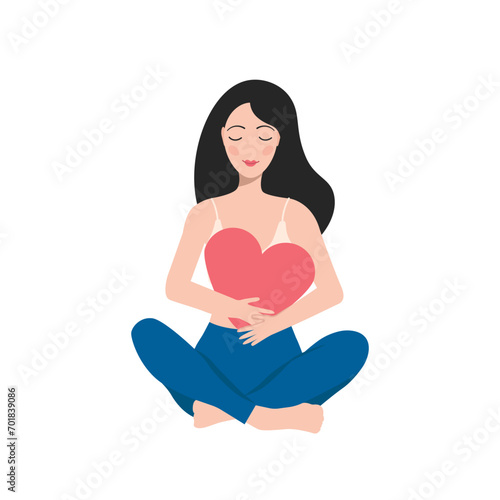 the girl sits in the lotus position and hugs a big heart. self love concept