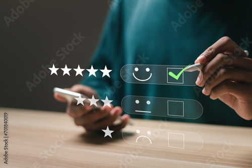 Customer satisfaction service concept. Businessman rate satisfaction by smiling face and 5-star satisfaction, on online application. satisfaction feedback review, good quality most.