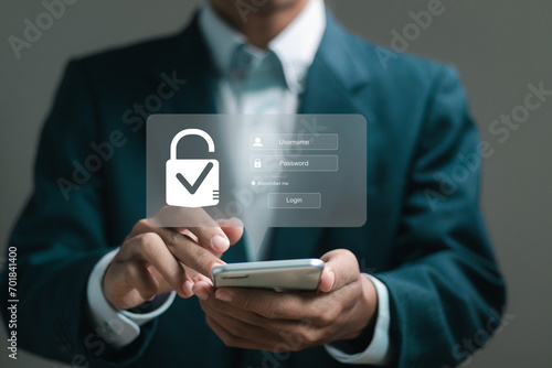 Cybersecurity and privacy concepts to protect data. Businessman use smartphone with cyber security technology for protecting personal data and secure internet access.