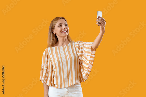 Smiling mature woman taking...