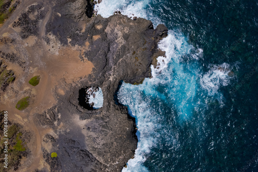 Aerial top view of 'Pont Naturel' which is a natural bridge formed by lava many years ago on the south coast of Mauritius island.