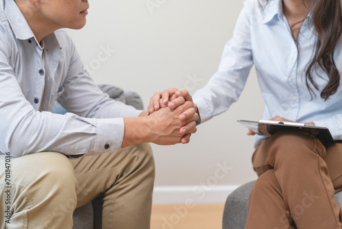 Man talking with mentor psychologist in therapy mental health anxiety session. photo