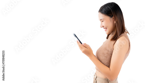 Happy excited young asian woman using mobile phone standing over isolated on white background and copy space Young girl using smartphone for shopping online chat and texting message She get surprised