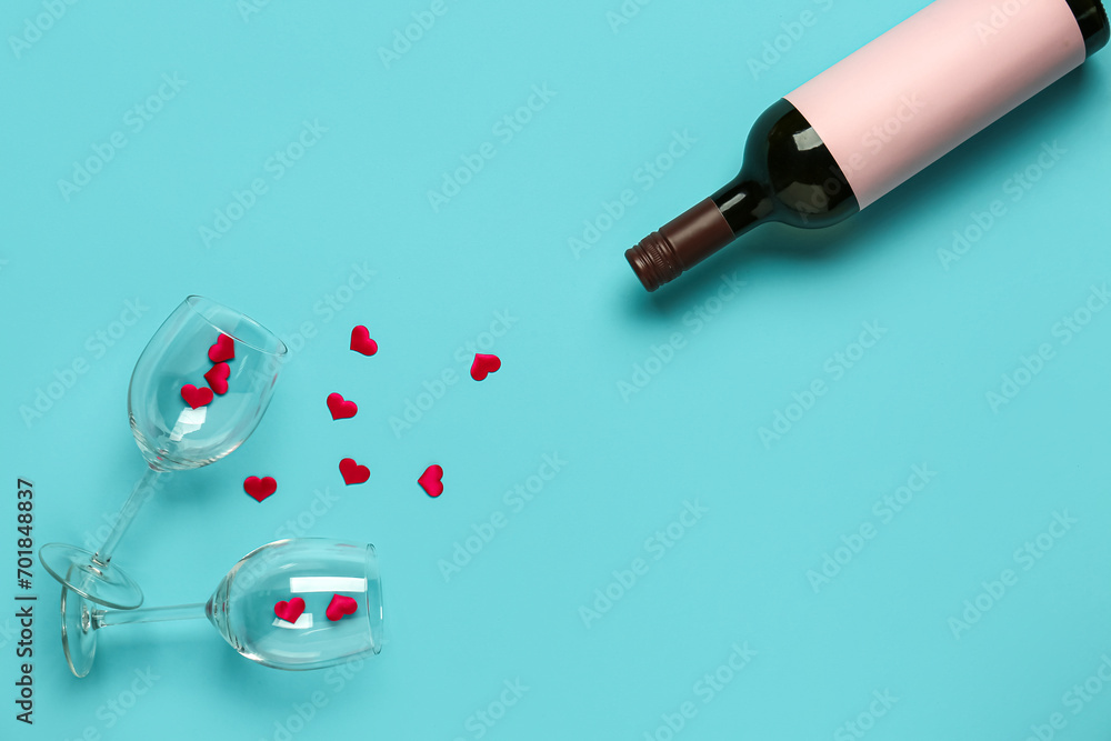 Bottle of wine, glasses and hearts on turquoise background. Valentine's Day celebration Bottle of wine, glasses and hearts on turquoise background. Valentine's Day celebration
