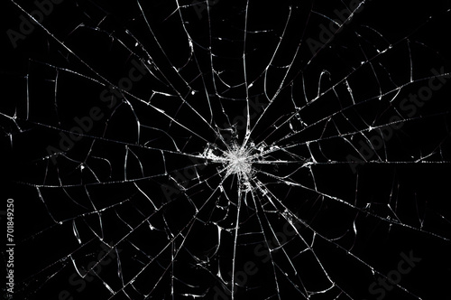 Photo of broken glass on a black background, cracks.