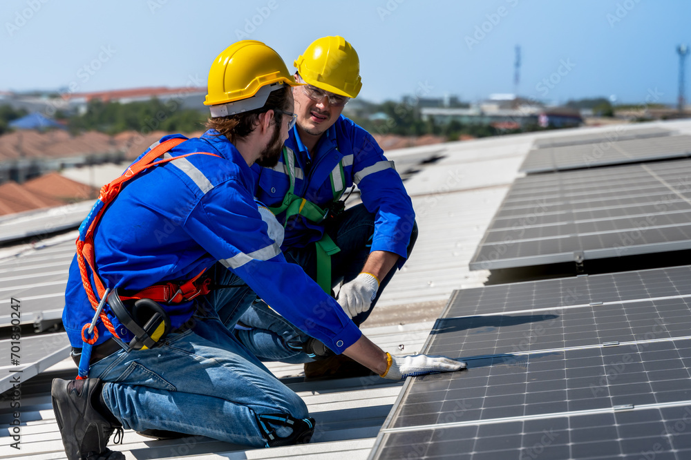 Expert solar engineer men installing solar panels on factory rooftop Expert solar engineer men installing solar panels on factory rooftop