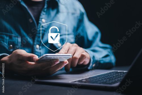 Cybersecurity and privacy concepts to protect data. Businessman use smartphone with cyber security technology for protecting personal data and secure internet access. photo