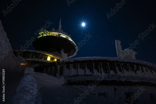 peak of Sniezka mountain at full moon night during in Giant mountains during winter