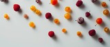 Scattered colourful candied and dried fruits on a light surface.