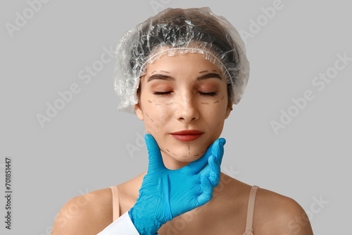 Young woman with marked fac...