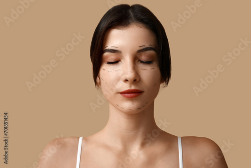Young woman with marked fac...