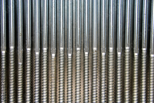 Fasteners. Metal screw screws on an iron background photo