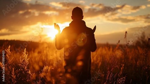The concept of contact with God through prayer, belief in supernatural powers, silhouette of a praying man