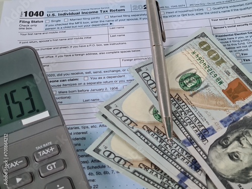US tax form 1040 with dollars and calculator
