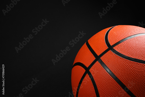 One basketball ball on black background, closeup. Space for text © New Africa