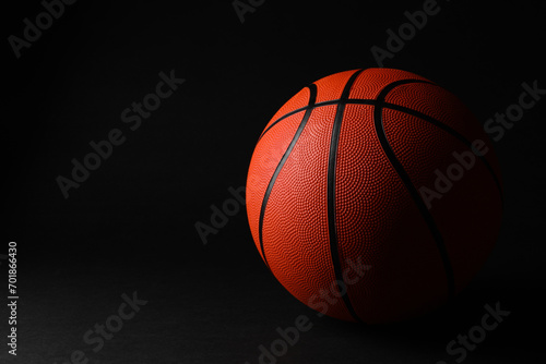 One basketball ball on black background. Space for text © New Africa