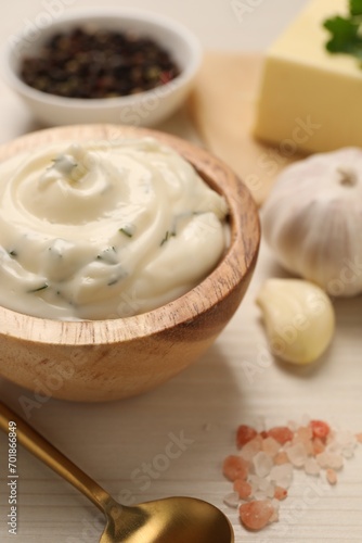 Tasty sauce with garlic and ingredients on white wooden table, closeup