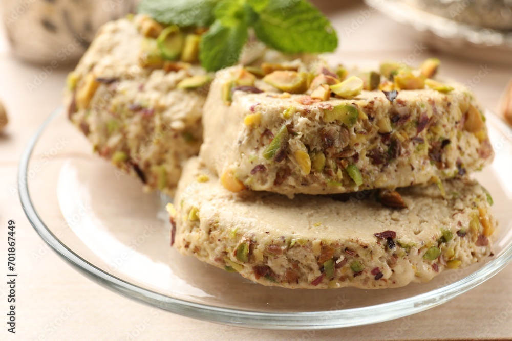 Tasty halva with pistachios and mint on table, closeup Tasty halva with pistachios and mint on table, closeup